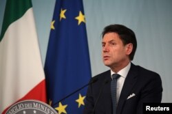 FILE - Giuseppe Conte, then Italy's prime minister, speaks to journalists at an impromptu news conference in Rome, Aug. 8, 2019.