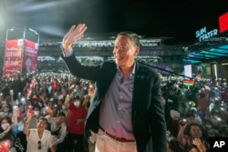 FILE - Real estate mogul Srettha Thavisin, one of the opposition Pheu Thai Party's three nominees to become the next prime minister, wave to supporters while campaigning in Bangkok, Thailand, Friday, May 5, 2023.