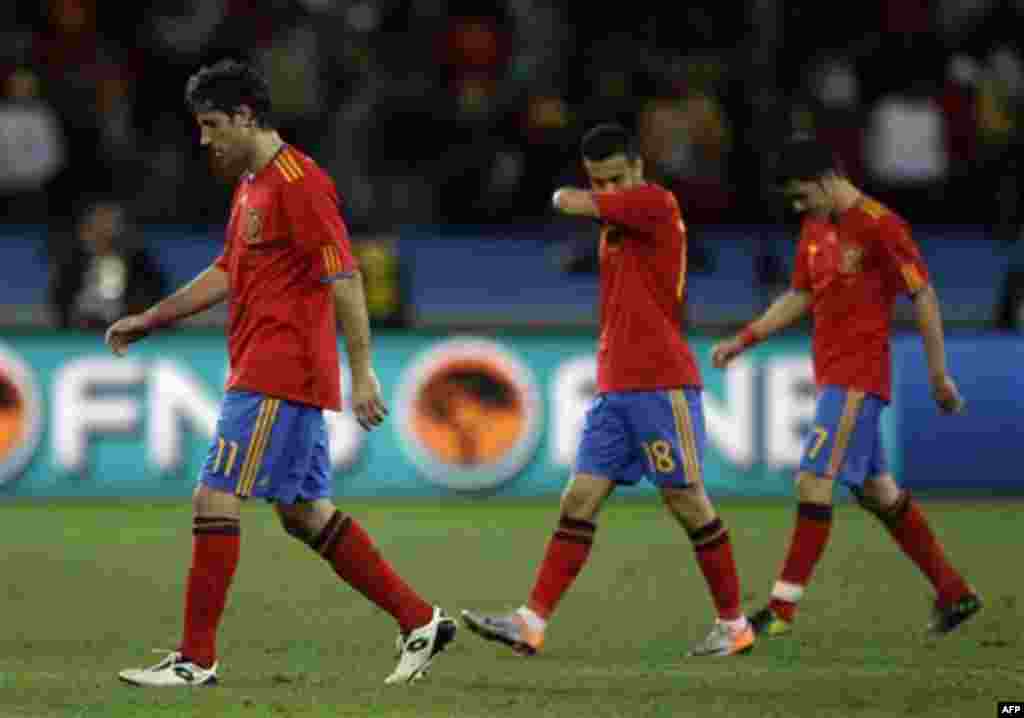 Spain's players from left, Joan Capdevila, Spain's Pedro Rodriguez, and Spain's David Villa leave the pitch after the World Cup group H soccer match between Spain and Switzerland at the stadium in Durban, South Africa, Wednesday, June 16, 2010. Switzerlan