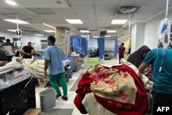 Patients and medics are seen at Al-Shifa hospital in Gaza City, Nov. 10, 2023. Heavy fighting was raging near Al-Shifa hospital, with Israel saying it had killed dozens of militants and destroyed tunnels that are key to Hamas's capacity to fight.