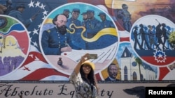 한 여성이 미 남부 텍사스주 갤버스틴에 있는 '절대적 평등' 벽화 앞에서 사진을 찍고 있다. (자료사진)