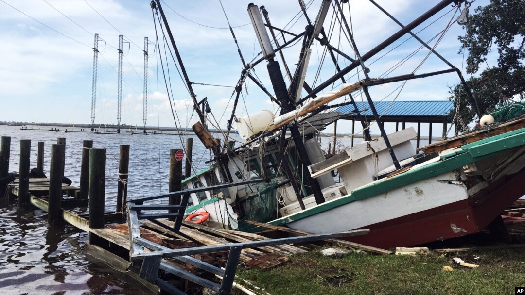 A shrimp boat is sunk at its mooring along the Pascagoula River in Moss Point, Mississippi, Oct. 8, 2017, after Hurricane Nate made landfall on Mississippi's Gulf Coast.