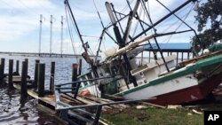 A shrimp boat is sunk at its mooring along the Pascagoula River in Moss Point, Mississippi, Oct. 8, 2017, after Hurricane Nate made landfall on Mississippi's Gulf Coast.