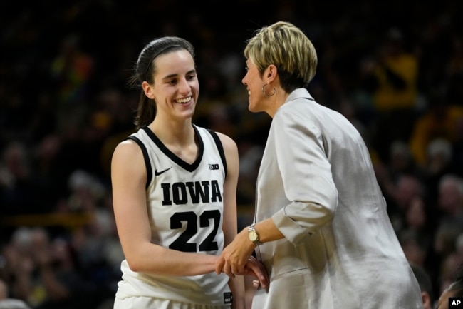 FILE - Iowa guard Caitlin Clark talks with assistant coach Jan Jensen during the second half of an NCAA college basketball game against Drake, Nov. 19, 2023, in Iowa City, Iowa. (AP Photo/Charlie Neibergall, file)