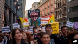 FILE - People take part in a Fridays For Future global climate protest against fossil fuel use in Madrid, Spain, Sept. 15, 2023. Various delegations at the COP27 climate conference were connected to the gas, coal and oil industries.
