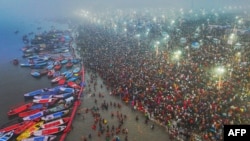 This aerial handout photograph taken and released by India's Uttar Pradesh State Information Department on January 13, 2025 shows Hindu pilgrims taking a holy dip in the sacred waters of Sangam, the confluence of Ganges, Yamuna and mythical Saraswati rive