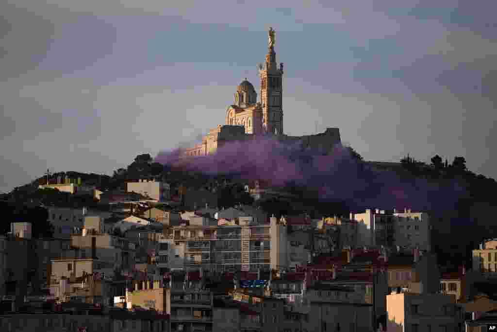 Stage technicians, theater administrators and actors set off smoke flares to demonstrate for more government support after the pandemic devastated their incomes, in front of the Notre-Dame de la Garde basilica in Marseille, southern France.