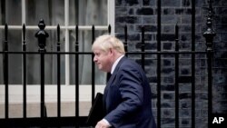 British Prime Minister Boris Johnson leaves 10 Downing Street to give a statement on Afghanistan at the Houses of Parliament, in London, Sept. 6, 2021. 