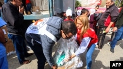 FILE - Workers and staff unload medical aid delivered by the International Committee of the Red Cross at Nasser hospital in Khan Yunis in southern Gaza Strip, on December 9, 2023, amid continuing battles between Israel and the militant group Hamas in the Palestinian territory.