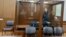 Dmitry Korotayev, detained on suspicion of the illegal circulation of means of payment as a member of the REvil ransomware crime group, stands inside a defendants' cage during a court hearing in Moscow, Russia, Jan. 15, 2022.