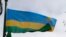 FILE - The Rwandan flag flies in the grounds of the Commonwealth Secretariat at Marlborough House, in London, on March 8, 2010, 