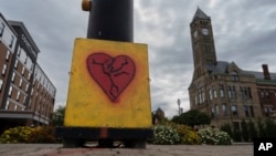 An representation  of a breached  bosom  is fixed crossed  the thoroughfare  from City Hall with the Heritage Center of Clark County, right, Sept. 17, 2024, successful  Springfield, Ohio.