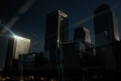 FILE - A general view shows the skyscrapers of the financial district of Canary Wharf, in London, Britain, March 24, 2020.