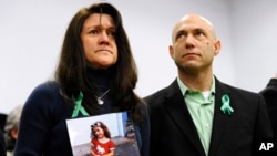 Jeremy Richman, with wife Jennifer Hensel holding a portrait of their daughter, Avielle Rose Richman, who was killed in the Sandy Hook school shooting, Newtown, Conn., Jan. 14, 2013. 