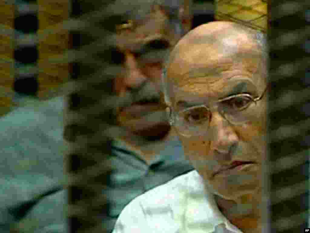On August 4, 2011, Ahmed Ramzy, former commander of riot police, known formally as Central Security Forces, is in a cage of mesh and iron bars during his trial in a Cairo courtroom. (AP/Egyptian State TV)