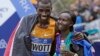 Kenya's Stanley Biwott (L) embraces fellow Kenyan Mary Keitany after the pair won the men's and women's professional athlete divisions in the the New York City marathon, Nov. 1, 2015, in New York.