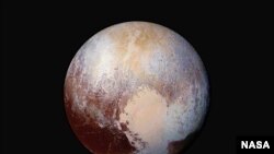 FILE - New Horizons scientists use enhanced color images to detect differences in the composition and texture of Pluto’s surface, image released July 24, 2015.