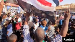 Protesters march during a rally against military rule following a coup nearly three months ago, in Khartoum, Sudan, Jan. 24, 2022.