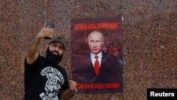 Activists mark Russian President Putin's birthday in Donetsk