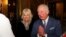 FILE - Britain's Prince Charles, with Camilla, Duchess of Cornwall, at his side, folds his hands in a "namaste" greeting, during a reception at Marlborough House, in London, Britain, March 9, 2020. 