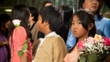 Children wait to greet Aung San Suu Kyi before her arrival at Voice of America in Washington, D.C., Sept. 18, 2012. (Alison Klein/VOA)