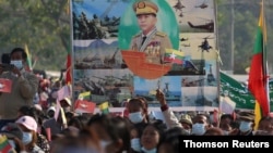 Military supporters carry a portrait of junta leader General Min Aung Hlaing as they celebrate the coup in Naypyitaw, Myanmar. (REUTERS)