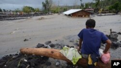 A man looks as floodwaters inundate an area as Typhoon Goni hit Daraga, Albay province, central Philippines, Nov. 1, 2020. 