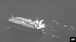 FILE - This still image from video released by the U.S. Navy shows the Panama-flagged oil tanker Niovi surrounded by Iranian Revolutionary Guard Corps vessels in the Strait of Hormuz, May 3, 2023.