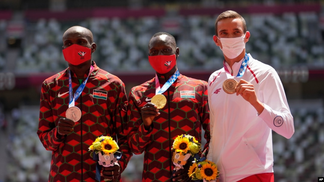 FILE - Gold medalist Emmanuel Korir, of Kenya, center, stands with silver medalist Ferguson Rotich, of Kenya, left, and bronze medalist Patryk Dobek, of Poland, for the men's 800-meter at the 2020 Summer Olympics, in Tokyo, Japan, Aug. 5, 2021.