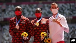 FILE - Gold medalist Emmanuel Korir, of Kenya, center, stands with silver medalist Ferguson Rotich, of Kenya, left, and bronze medalist Patryk Dobek, of Poland, for the men's 800-meter at the 2020 Summer Olympics, in Tokyo, Japan, Aug. 5, 2021.