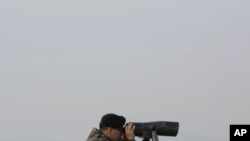 FILE - A South Korean army soldier watches the North Korea side from the Unification Observation Post in Paju, South Korea, near the border with North Korea, Dec. 25, 2019. 