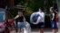 Students and parents begin to move student's belongings out of Bragaw Hall at N.C. State University in Raleigh, N.C., Aug. 27, 2020. 