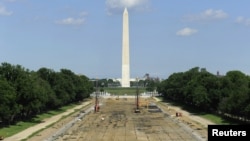 Tourists walk past work underway to reconstruct the Lincoln Memorial Reflecting Pool on the National Mall in Washington, May 11, 2011.