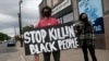 People gather to protest the death of a black man Monday night in police custody in Minneapolis, May 26, 2020.