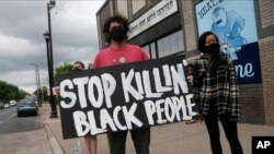 People gather to protest the death of a black man Monday night in police custody in Minneapolis, May 26, 2020.