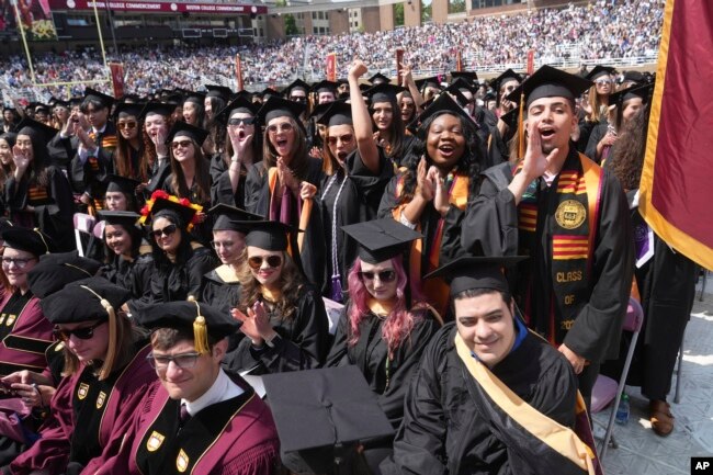 FILE - Graduating Boston College students cheer during commencement ceremonies, Monday, May 22, 2023, in Boston. (AP Photo/Steven Senne)