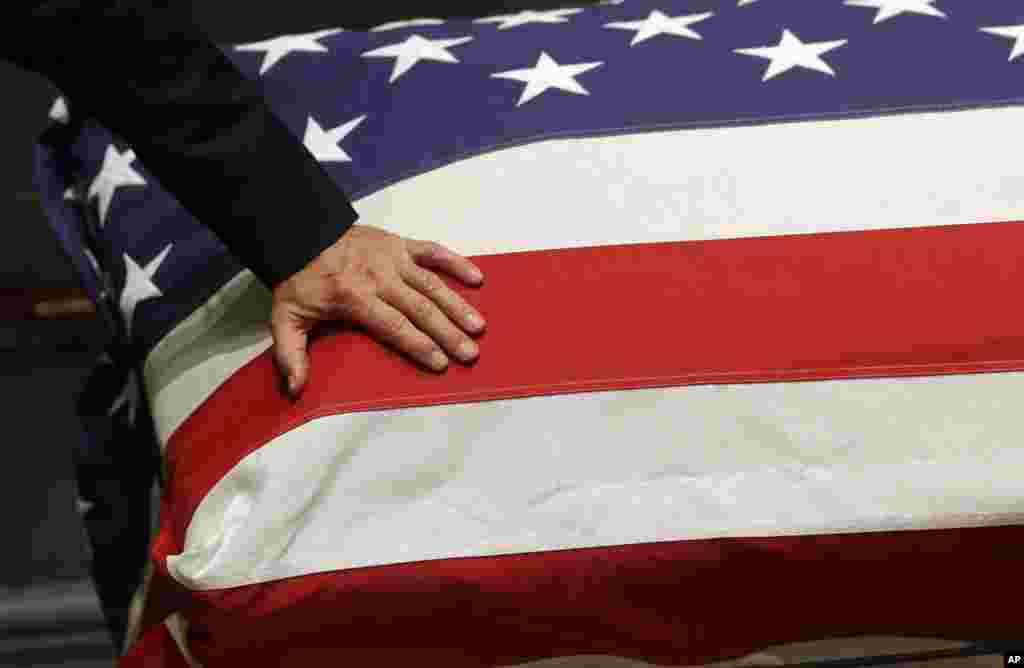 Vice President Joe Biden rests his hand on the casket of his son, former Delaware Attorney General Beau Biden during a visitation, at Legislative Hall in Dover, Delaware, June 4, 2015.