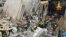 This handout picture taken and released by Italian Firefighters (Vigili del Fuoco) on December 12, 2021 shows firefighters working after a four-storey apartment building collapsed, following a gas explosion, in Ravanusa on Dec. 12, 2021.