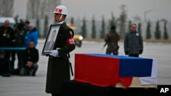 A Turkish forces honor guard stands by the flag-draped coffin of Russian Ambassador to Turkey Andrei Karlov, who was assassinated Monday, during a ceremony at the airport in Ankara, Turkey, Dec, 20, 2016.