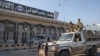 Syrian opposition fighters ride on a pickup truck at the Aleppo international airport in Aleppo, Syria, Dec. 2, 2024.