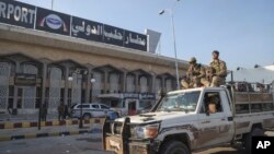 Syrian opposition fighters ride on a pickup truck at the Aleppo international airport in Aleppo, Syria, Dec. 2, 2024.