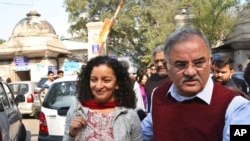 FILE - Indian journalist Priya Ramani, left, smiles as she leaves Patiala House Court in New Delhi, India, Feb. 25, 2019. A New Delhi court on Feb. 17, 2021, acquitted Ramani of criminal defamation after she accused a politician of sexual harassment.