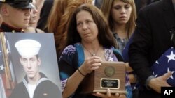 Elizabeth Strange, center, carries her son's remains,at a flag presentation ceremony for U.S. Navy Petty Officer 1st Class Michael Joseph Strange, in Philadelphia on August18, 2011. Strange was assigned to the Navy SEAL team whose Chinook helicopter was s