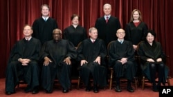 In April 23, 2021, photo, Supreme Court members pose for a group photo. Seated from left: Samuel Alito, Clarence Thomas, John Roberts, Stephen Breyer and Sonia Sotomayor. Standing from left: Brett Kavanaugh, Elena Kagan, Neil Gorsuch, Amy Coney Barrett.