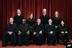 In April 23, 2021, photo, Supreme Court members pose for a group photo. Seated from left: Samuel Alito, Clarence Thomas, John Roberts, Stephen Breyer and Sonia Sotomayor. Standing from left: Brett Kavanaugh, Elena Kagan, Neil Gorsuch, Amy Coney Barrett.