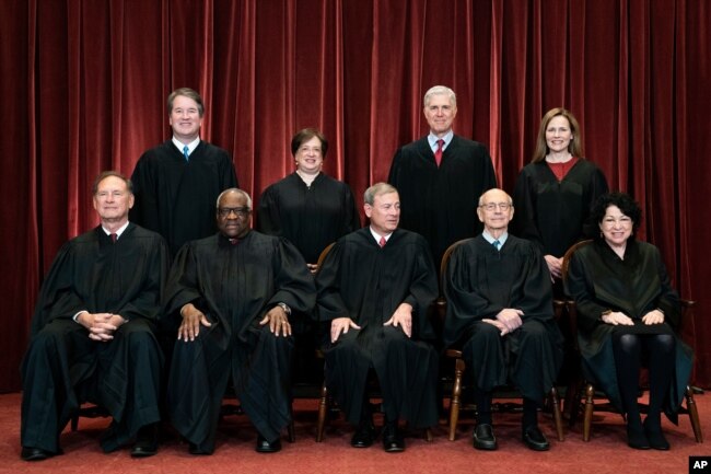 In April 23, 2021, photo, Supreme Court members pose for a group photo. Seated from left: Samuel Alito, Clarence Thomas, John Roberts, Stephen Breyer and Sonia Sotomayor. Standing from left: Brett Kavanaugh, Elena Kagan, Neil Gorsuch, Amy Coney Barrett.