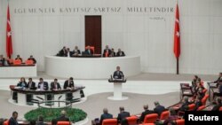 Ismet Yilmaz, head of the parliament's national defense committee from the ruling AK Party, addresses lawmakers at the Turkish Parliament in Ankara, Turkey, Jan. 2, 2020. 