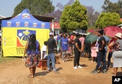 FILE - Voters queue to cast their votes in Manzini, Eswatini, Sept. 29, 2023.