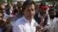 Imran Khan, cricketer-turned-politician and head of Pakistan Tehreek-e-Insaf (PTI) is surrounded with supporters as he leaves to lead a peace march against U.S. drone strikes from Islamabad to South Waziristan, October 6, 2012. 