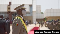 FILE - Interim Malian President, Colonel Assimi Goita, looks on at members of the Malian Armed Forces after his swearing in ceremony in Bamako on June 7, 2021.
